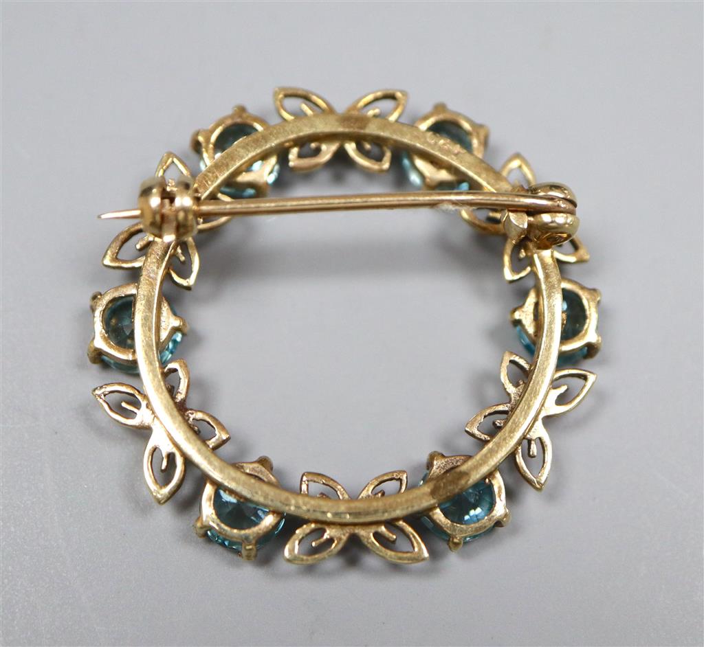 A modern 9ct gold and blue zircon set openwork circular brooch, 30mm,